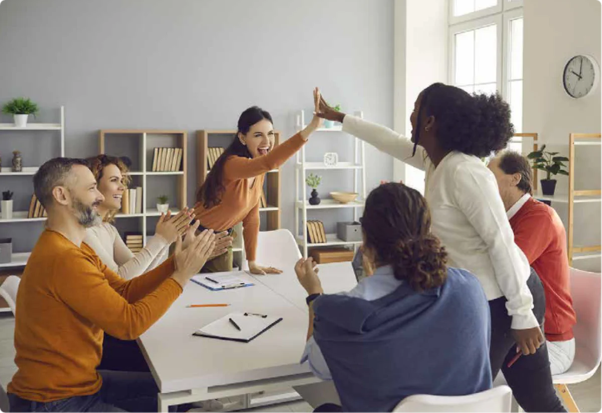 A retail team celebrating with a high five